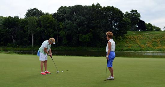 Women putting at Keller Golf Course Women putting at Keller Golf Course
